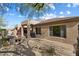 The backyard has a covered patio and desert landscaping that includes cacti and gravel at 6579 E Shooting Star Way, Scottsdale, AZ 85266