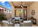 Comfortable covered patio with ceiling fan, ample seating, and serene outdoor living space at 6579 E Shooting Star Way, Scottsdale, AZ 85266