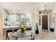 Inviting entryway with views of a modern kitchen featuring stainless steel appliances and a breakfast bar at 6579 E Shooting Star Way, Scottsdale, AZ 85266