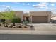 Charming single-story home featuring a low-maintenance desert landscape and a two-car garage at 6579 E Shooting Star Way, Scottsdale, AZ 85266