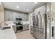Modern kitchen featuring stainless steel appliances, sleek gray cabinetry, and ample countertop space at 6579 E Shooting Star Way, Scottsdale, AZ 85266