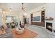 Open-concept living room with modern fireplace, built-ins, and easy access to the kitchen and dining area at 6579 E Shooting Star Way, Scottsdale, AZ 85266