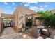 A cozy outdoor patio setup features a dining table under an umbrella, surrounded by lush greenery at 6579 E Shooting Star Way, Scottsdale, AZ 85266