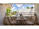Outdoor balcony with table and chairs, overlooking landscaped green space and clear blue skies at 7350 N Via Paseo Del Sur -- # O202, Scottsdale, AZ 85258