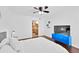 Bright bedroom with modern decor, ceiling fan, and doorway leading to kitchen and laundry at 7350 N Via Paseo Del Sur -- # O202, Scottsdale, AZ 85258