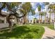 Community courtyard with walking path and mature shade trees, adding to the beauty at 7350 N Via Paseo Del Sur -- # O202, Scottsdale, AZ 85258