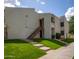 Exterior view of a two-story apartment building with well-maintained lawn and walkway at 7350 N Via Paseo Del Sur -- # O202, Scottsdale, AZ 85258