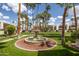 Beautiful fountain surrounded by lush green lawn and palm trees in a community setting at 7350 N Via Paseo Del Sur -- # O202, Scottsdale, AZ 85258