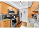 Modern kitchen boasts stainless steel appliances, granite counters, and ample wood cabinetry at 7350 N Via Paseo Del Sur -- # O202, Scottsdale, AZ 85258