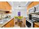 Bright kitchen featuring stainless steel appliances, granite countertops, and wood flooring at 7350 N Via Paseo Del Sur -- # O202, Scottsdale, AZ 85258