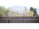 Fenced backyard offering privacy with mountain views as seen from behind the block fence at 749 N 99Th St, Mesa, AZ 85207