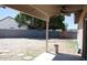 The covered patio looks out to the backyard with a block fence at 749 N 99Th St, Mesa, AZ 85207