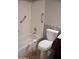 Bright bathroom features a tub with safety bars and a white toilet with mosaic tile accents at 749 N 99Th St, Mesa, AZ 85207