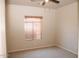 This carpeted bedroom features a ceiling fan and wood blinds at 749 N 99Th St, Mesa, AZ 85207