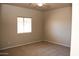 Neutral carpeted bedroom is well lit with a window and overhead fan at 749 N 99Th St, Mesa, AZ 85207