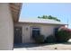 Exterior view showing a home's front door and windows, accented by lush landscaping at 749 N 99Th St, Mesa, AZ 85207