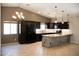 Open kitchen design with dark cabinets, light countertops, and an eat-in island bar at 749 N 99Th St, Mesa, AZ 85207