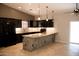 Modern kitchen features dark cabinets, granite countertops, and a stylish stone-clad breakfast bar at 749 N 99Th St, Mesa, AZ 85207