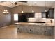Modern kitchen features dark cabinets, granite countertops, and a stylish stone-clad breakfast bar at 749 N 99Th St, Mesa, AZ 85207