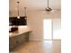 Open concept kitchen and dining features a breakfast bar, modern lighting, and neutral paint at 749 N 99Th St, Mesa, AZ 85207