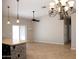 Open concept living area features stylish lighting, neutral paint, and easy access to kitchen at 749 N 99Th St, Mesa, AZ 85207