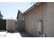 Home's side yard featuring secure fencing and access gate, providing a private outdoor space at 749 N 99Th St, Mesa, AZ 85207