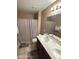 Bathroom featuring a double vanity, toilet, and shower with tub at 7521 S 31St Pl, Phoenix, AZ 85042