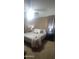 Primary bedroom with king bed, side tables, and neutral toned decor at 7521 S 31St Pl, Phoenix, AZ 85042