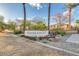 View of the Hunter Ridge II community sign with lush landscaping and palm trees against a blue sky at 7521 S 31St Pl, Phoenix, AZ 85042