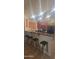 Bright kitchen featuring a breakfast bar with seating and dark wood cabinets at 7521 S 31St Pl, Phoenix, AZ 85042
