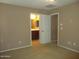 Main bedroom showing a view into the ensuite bathroom and walk-in closet with neutral carpeting at 7521 S 31St Pl, Phoenix, AZ 85042