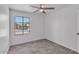 Bright bedroom with wood-look tile flooring, a ceiling fan, and a window at 7614 W Cheery Lynn Rd, Phoenix, AZ 85033