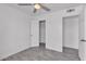 Neutral bedroom with wood-look tile flooring, offering closet and hallway access at 7614 W Cheery Lynn Rd, Phoenix, AZ 85033