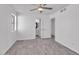 This bedroom has wood-style flooring, a ceiling fan, and a view into the bathroom at 7614 W Cheery Lynn Rd, Phoenix, AZ 85033