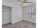 Bright bedroom features a closet, wood floors, a ceiling fan, and a secure window at 7614 W Cheery Lynn Rd, Phoenix, AZ 85033