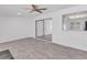 Open living space with gray wood-style flooring, glass sliding doors and a window at 7614 W Cheery Lynn Rd, Phoenix, AZ 85033