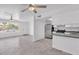 Open-concept living space featuring wood-look tile floors, modern appliances, and ample natural light at 7614 W Cheery Lynn Rd, Phoenix, AZ 85033