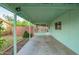Spacious covered back porch with access to a screened in porch, and a lush yard at 811 W Ocotillo Rd, Phoenix, AZ 85013