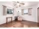 Spacious bedroom featuring hardwood floors, two windows, and a ceiling fan at 811 W Ocotillo Rd, Phoenix, AZ 85013