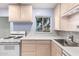 Bright kitchen features light-toned cabinets, a gas range, and ample counter space at 811 W Ocotillo Rd, Phoenix, AZ 85013