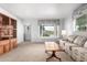 Bright living room featuring plush carpet and a large window overlooking the front yard at 811 W Ocotillo Rd, Phoenix, AZ 85013