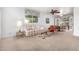 Cozy living room featuring neutral carpet, a ceiling fan, and a view of the yard at 811 W Ocotillo Rd, Phoenix, AZ 85013