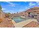 The backyard includes a pool with a covered patio and outdoor kitchen at 8420 W Cherry Hills Dr, Peoria, AZ 85345