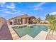 Beautiful backyard with a sparkling pool, covered patio, and ample space for outdoor living and entertaining at 8420 W Cherry Hills Dr, Peoria, AZ 85345