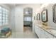 Bright bathroom with white cabinets, marble countertops, and a glass-enclosed shower at 8420 W Cherry Hills Dr, Peoria, AZ 85345