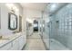 Bright main bathroom with dual sinks, marble countertops, and a glass-enclosed tiled shower at 8420 W Cherry Hills Dr, Peoria, AZ 85345