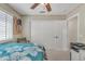 Well-lit bedroom with white closet doors, a ceiling fan, and plantation shutters allowing for natural light at 8420 W Cherry Hills Dr, Peoria, AZ 85345