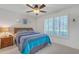 Comfortable bedroom with a wooden nightstand, bed, window with white shutters, and overhead fan at 8420 W Cherry Hills Dr, Peoria, AZ 85345