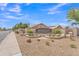 Bridlewood community entrance featuring manicured landscaping and welcoming signage under a beautiful blue sky at 8420 W Cherry Hills Dr, Peoria, AZ 85345