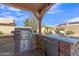 Outdoor kitchen area with stainless steel grill, stone counter, mini refrigerator and stone accents at 8420 W Cherry Hills Dr, Peoria, AZ 85345